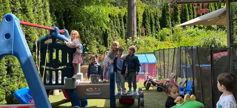 Children playing together on the outdoor playground at Sweet House Daycare